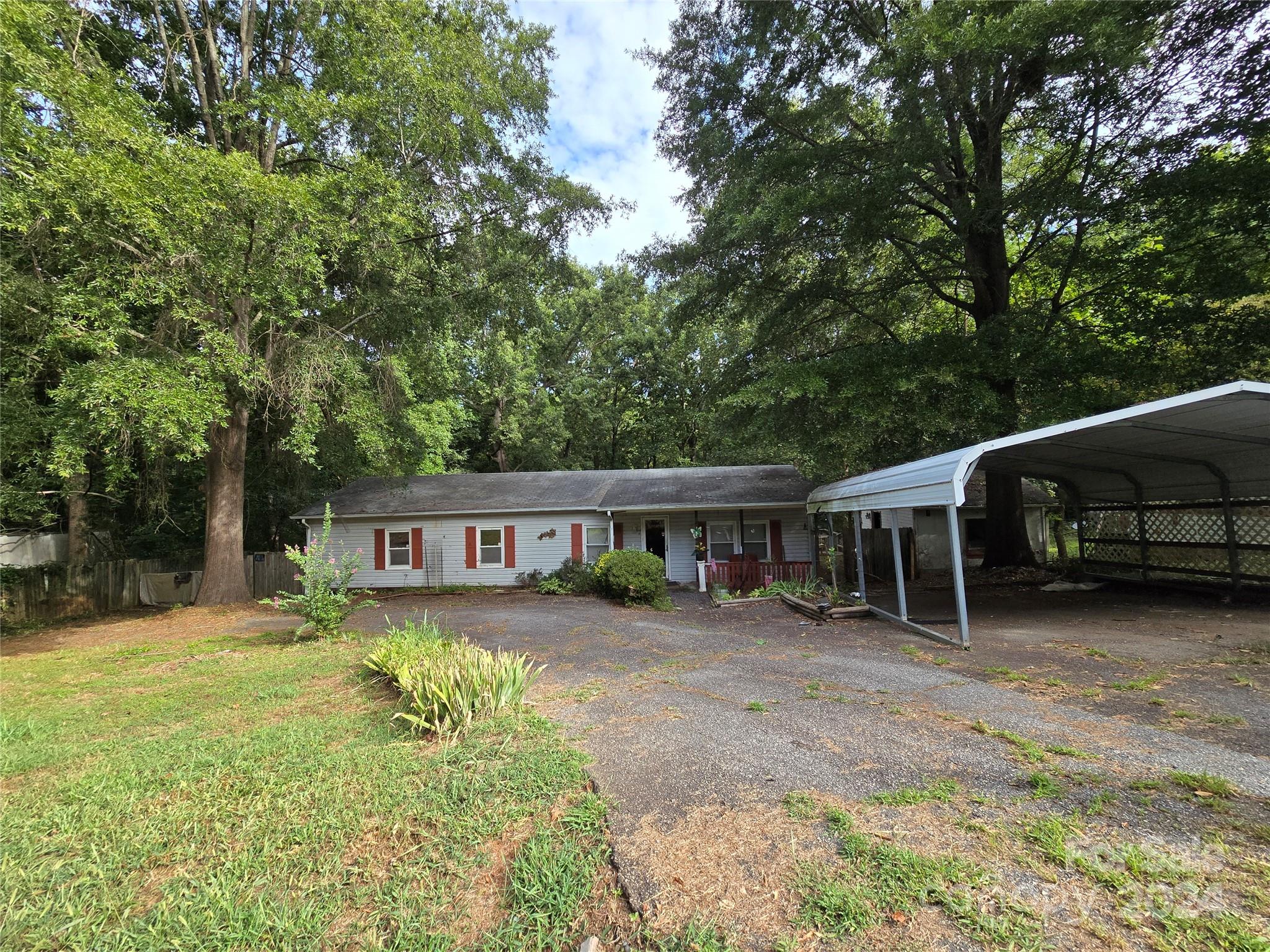 a view of a house with a yard and sitting area