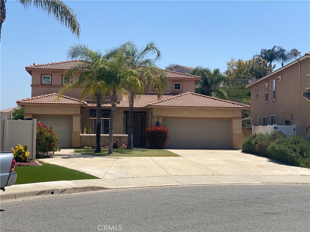 a view of a house with outdoor space and palm trees