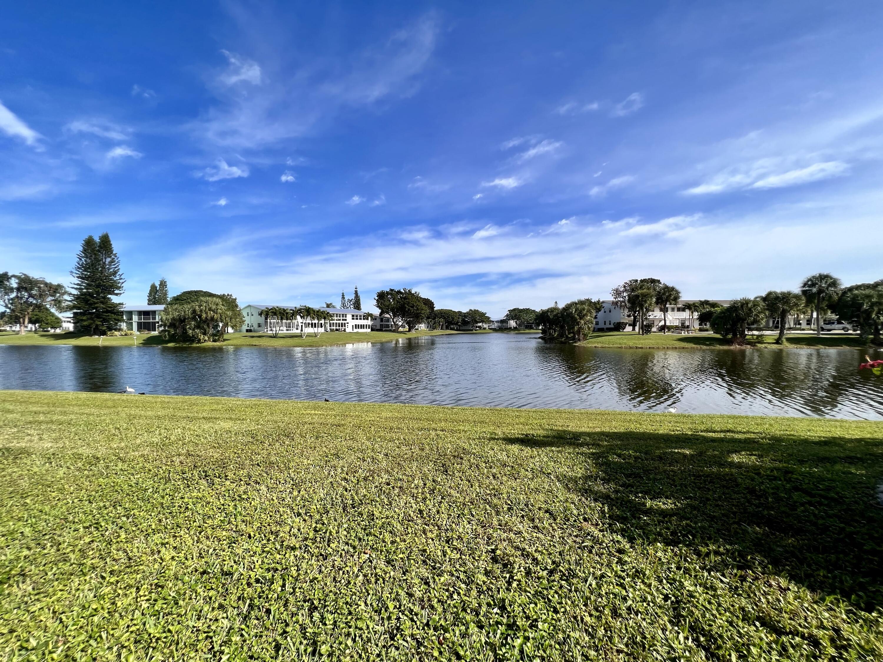 a view of a lake with houses in the back