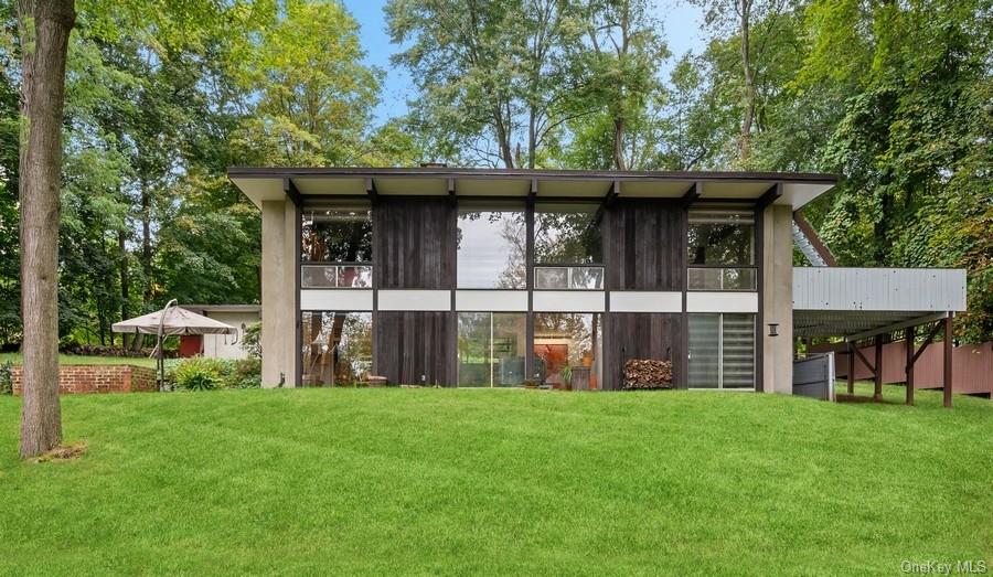 a view of house with backyard and a tub