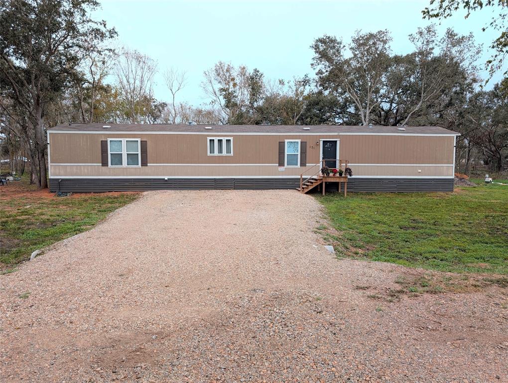 Front view of home with new gravel driveway