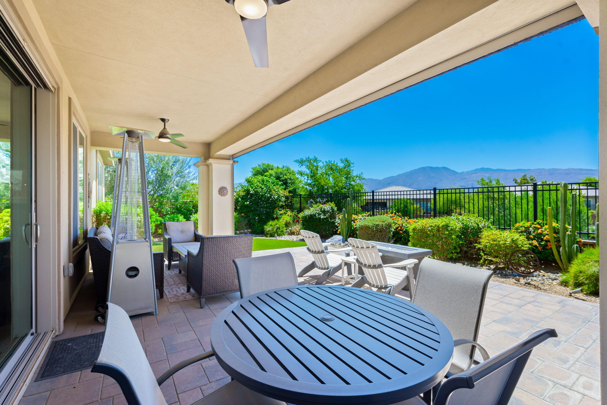 a view of a patio with a table chairs and a potted plants