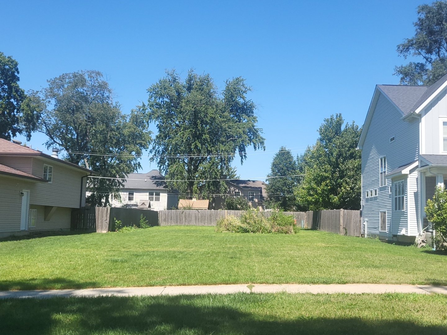 a view of a house with a yard and a garden