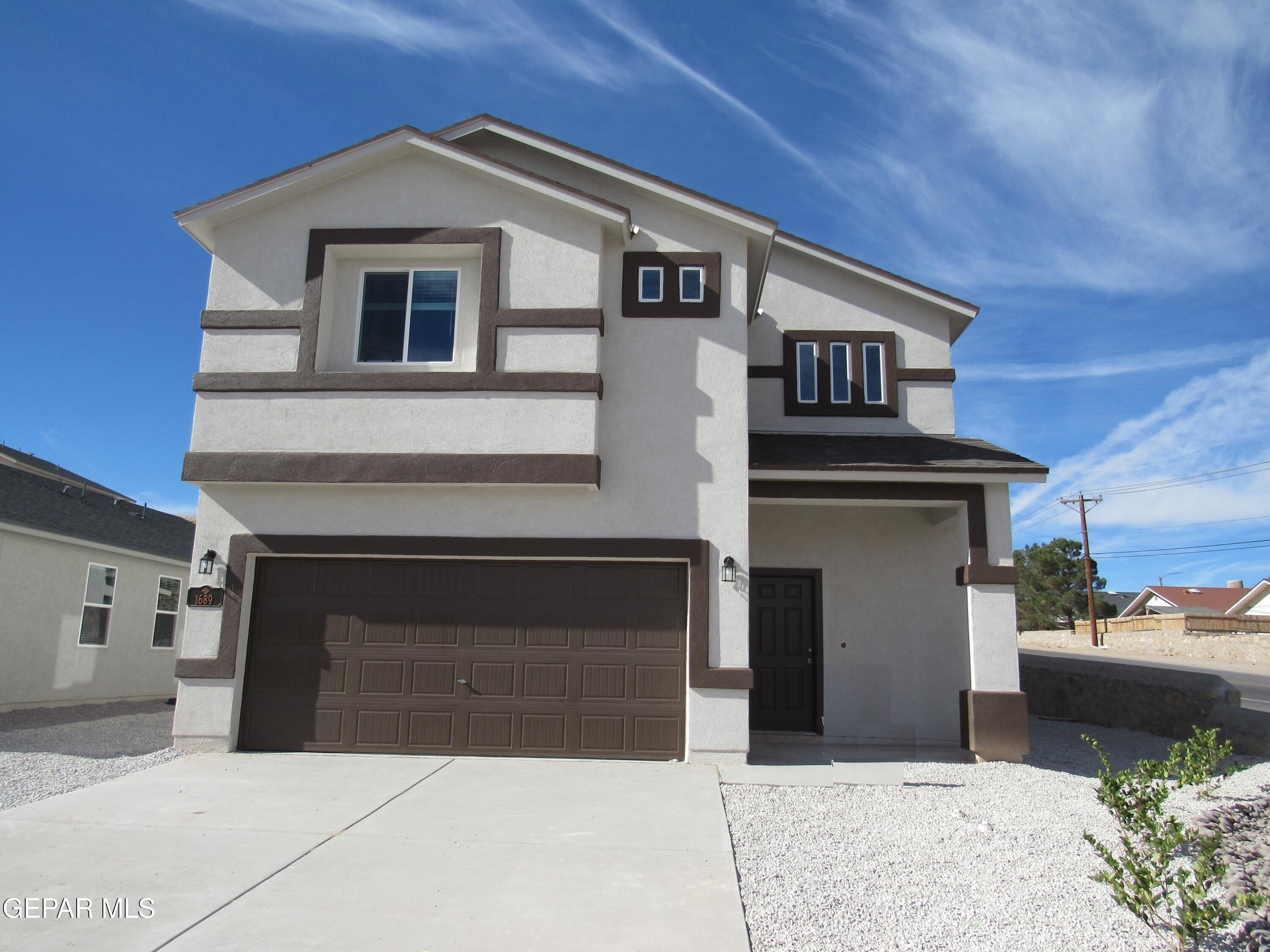 a front view of a house with garage