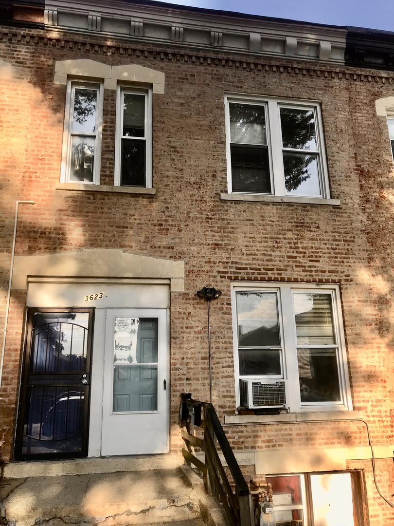 a view of a brick building with many windows