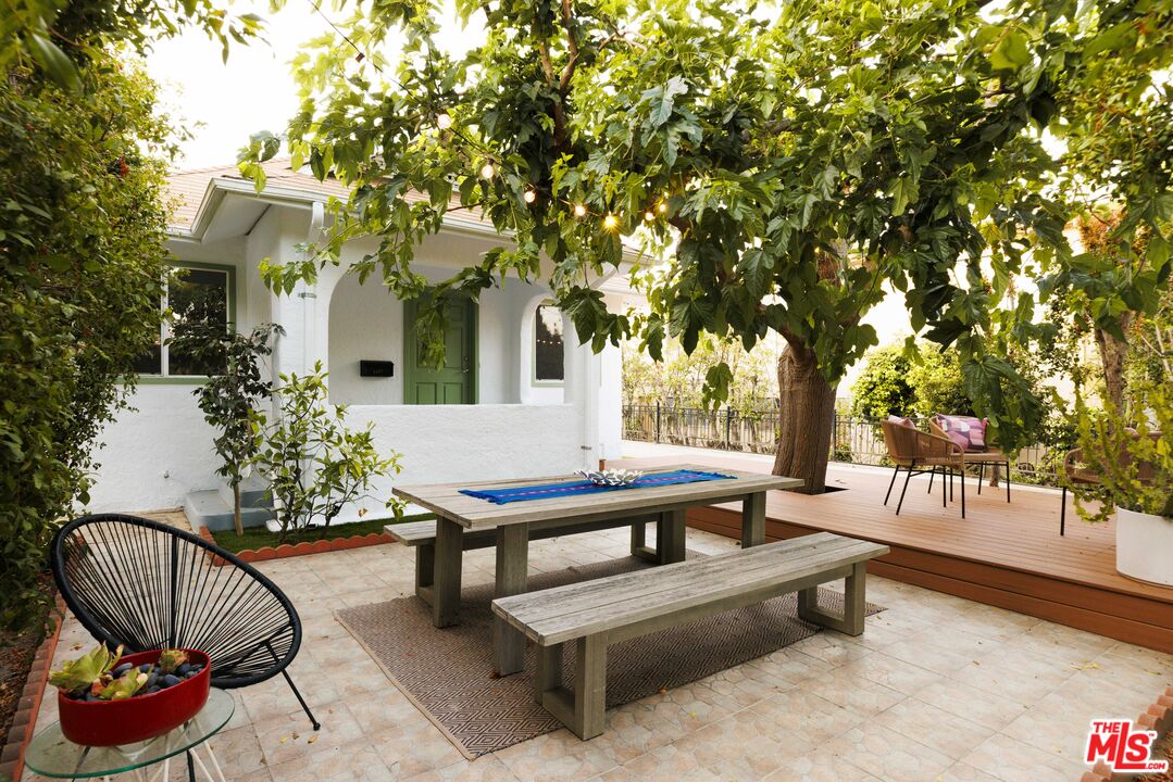 a view of a house with backyard and sitting area