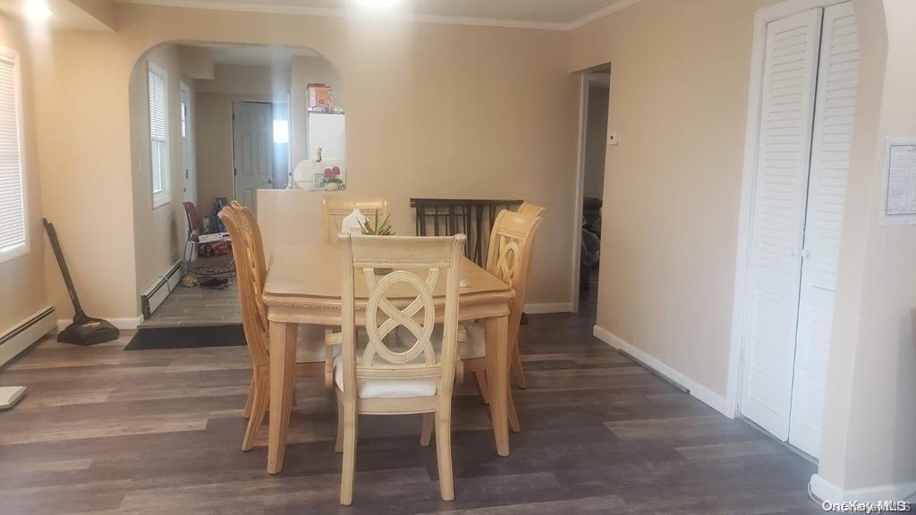 a dining room with furniture and wooden floor