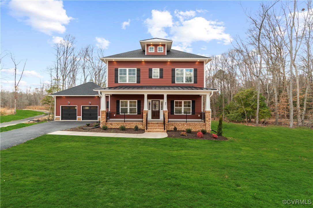 Craftsman inspired home featuring a garage, covere