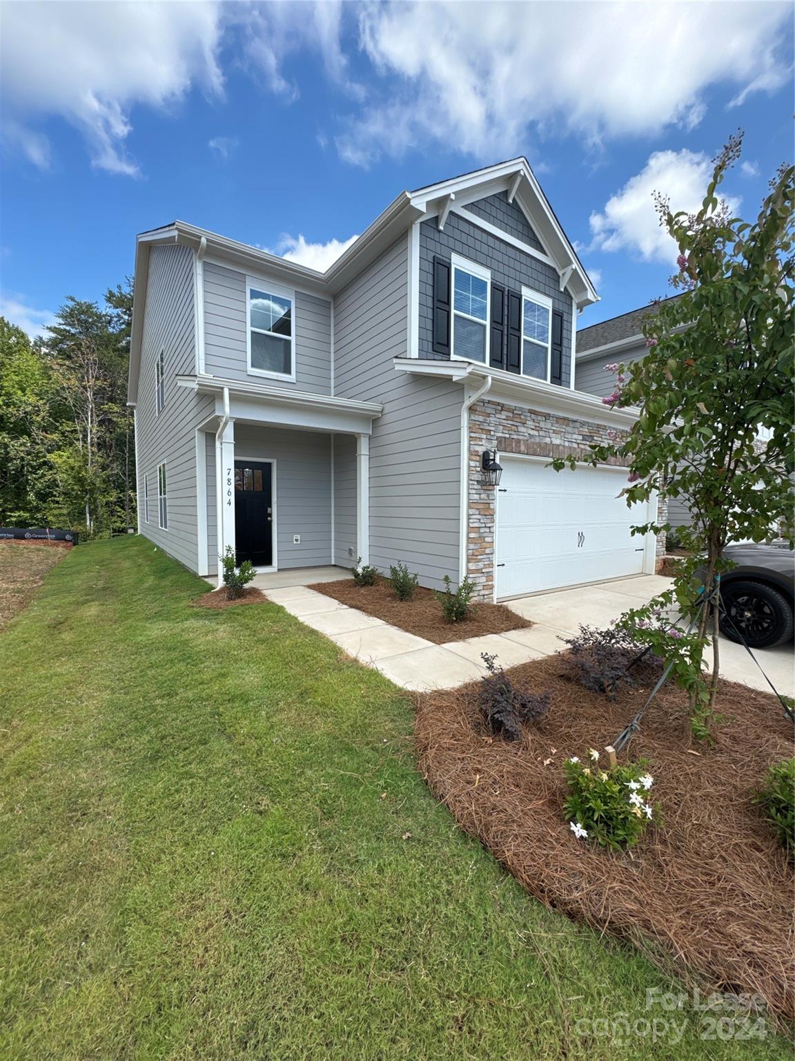 a front view of a house with a garden