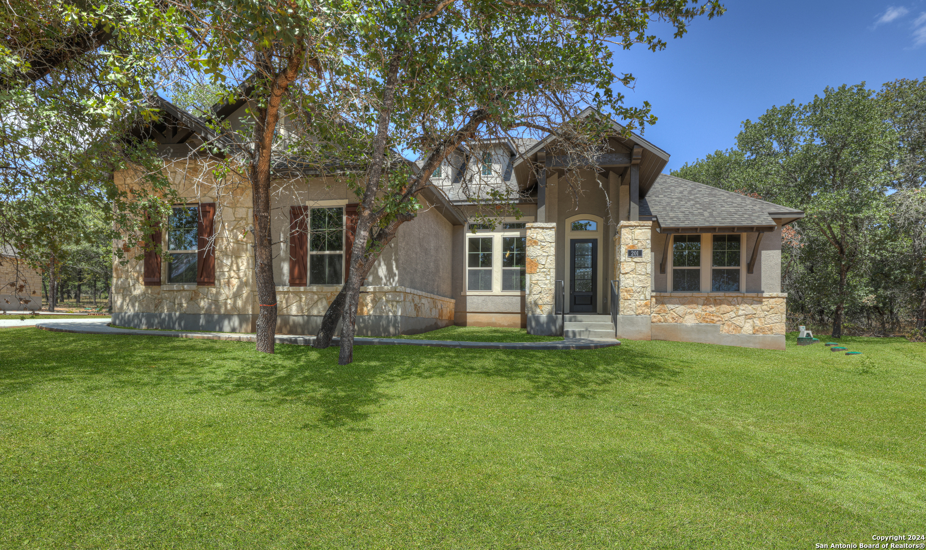 a front view of a house with a garden