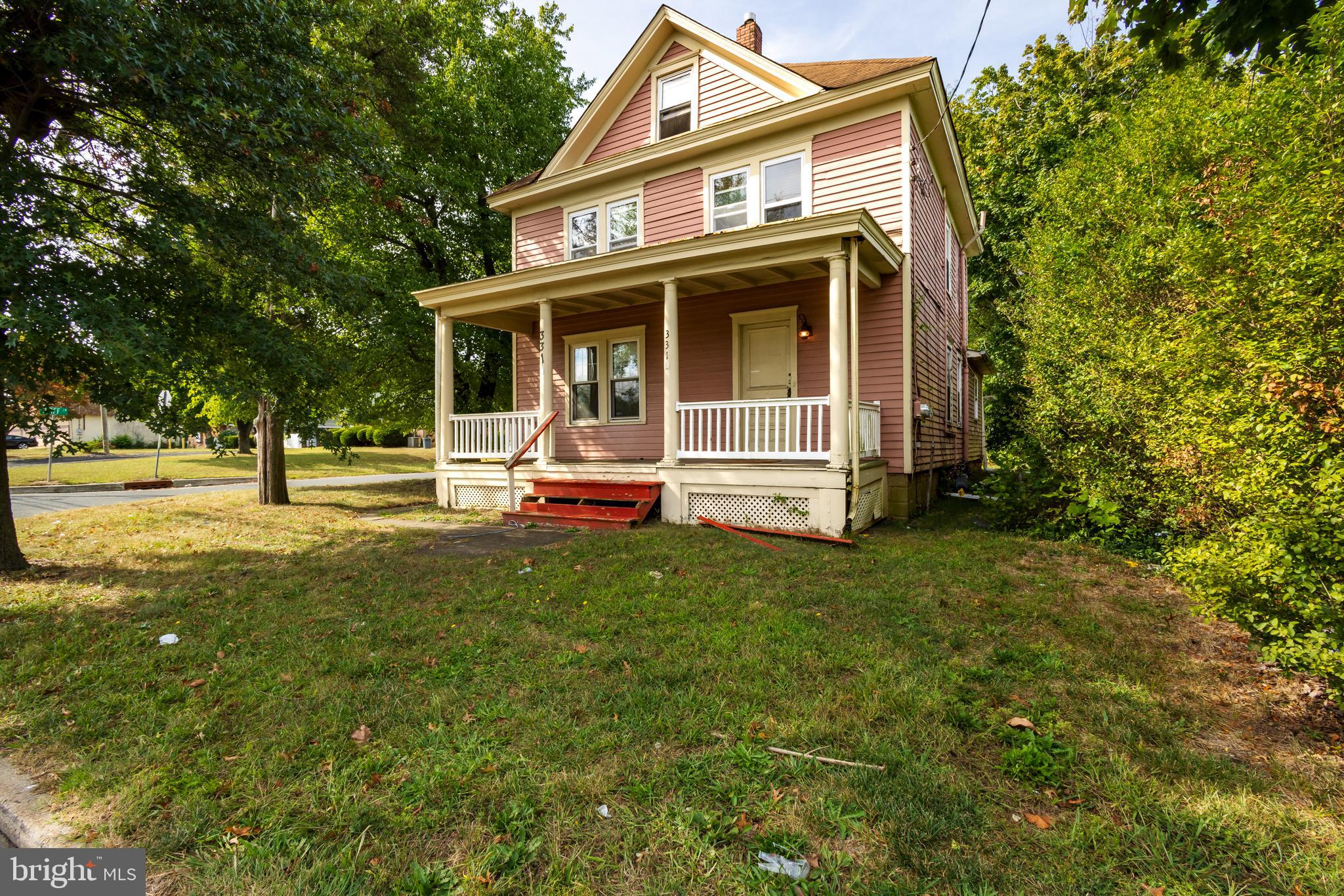 a view of a house with a yard patio and fire pit