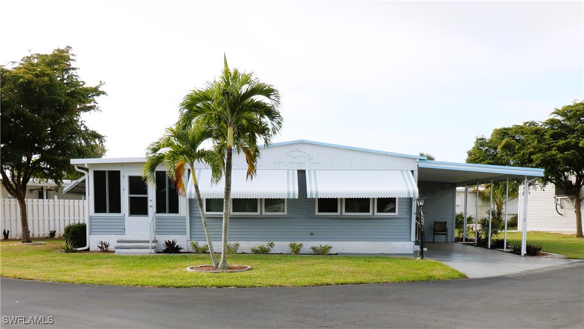 a view of a house with a swimming pool and a yard