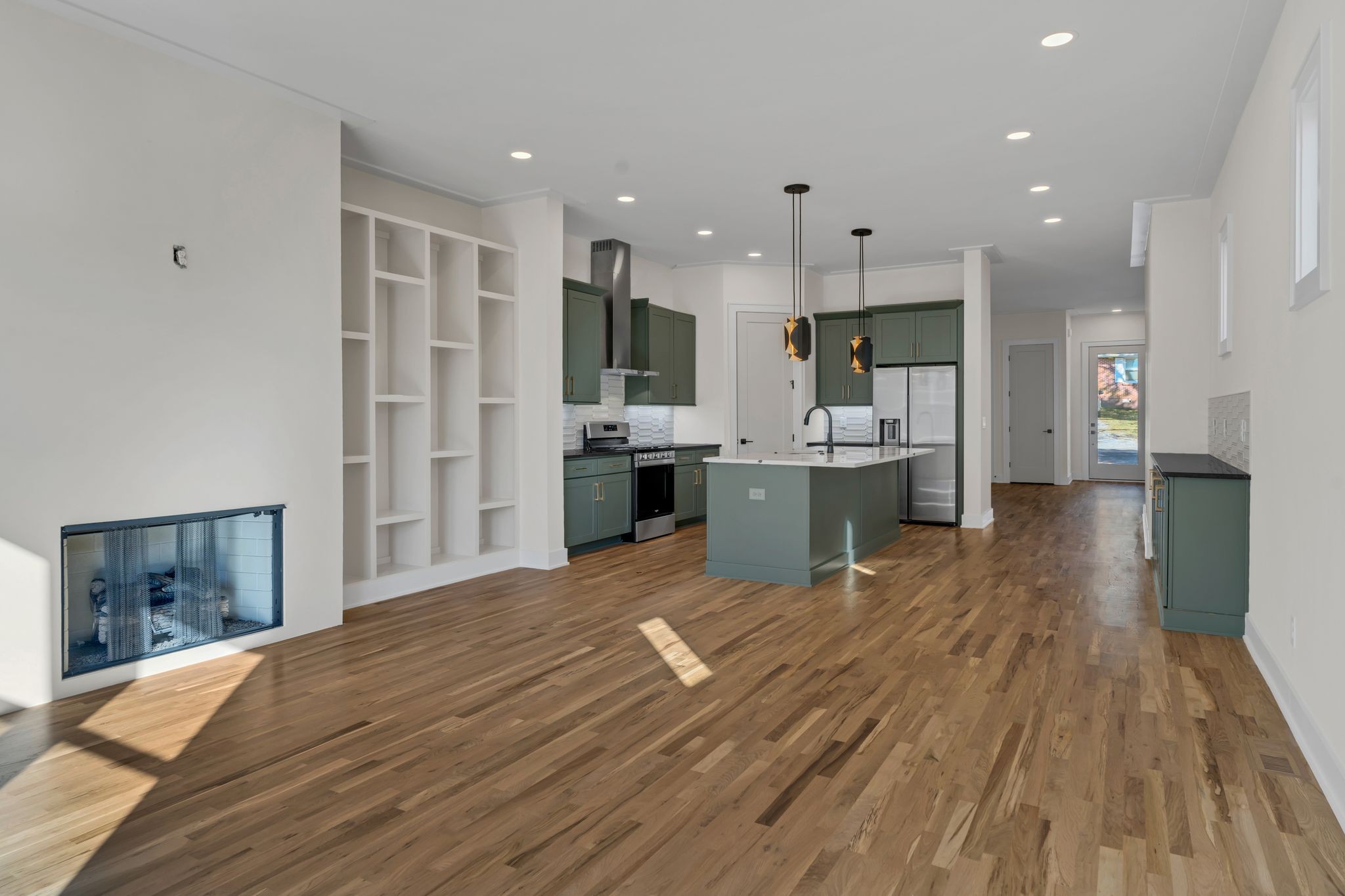 a large kitchen with stainless steel appliances granite countertop a lot of counter space and wooden floors