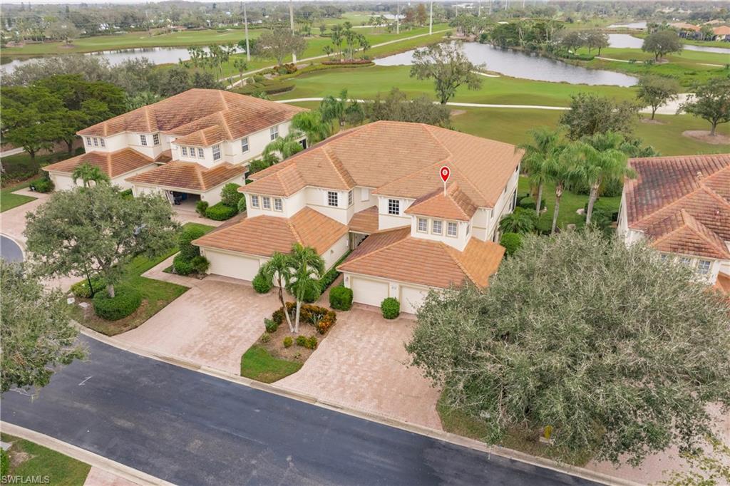 an aerial view of a house with outdoor space and lake view