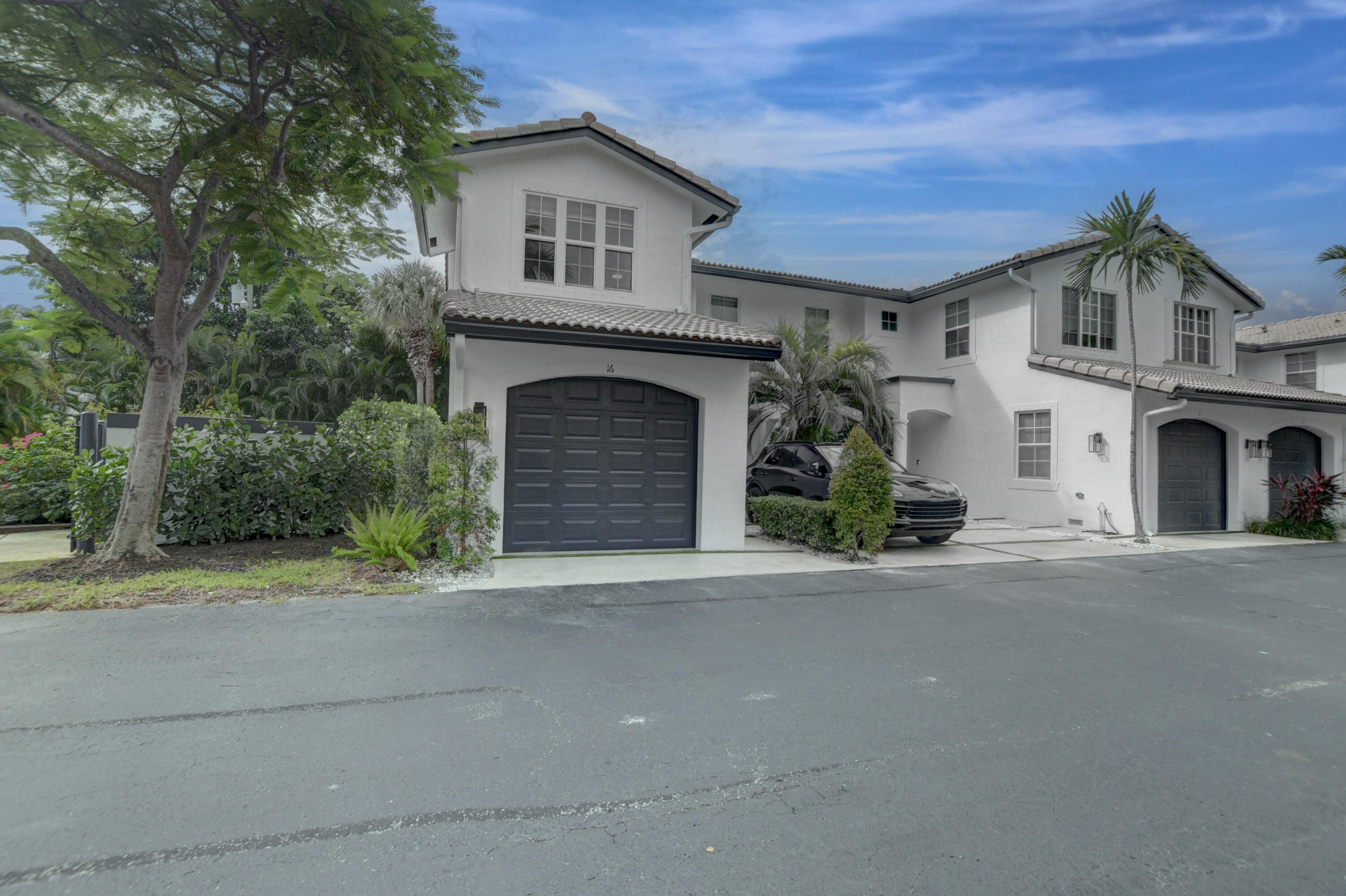 a view of a house with a yard and garage