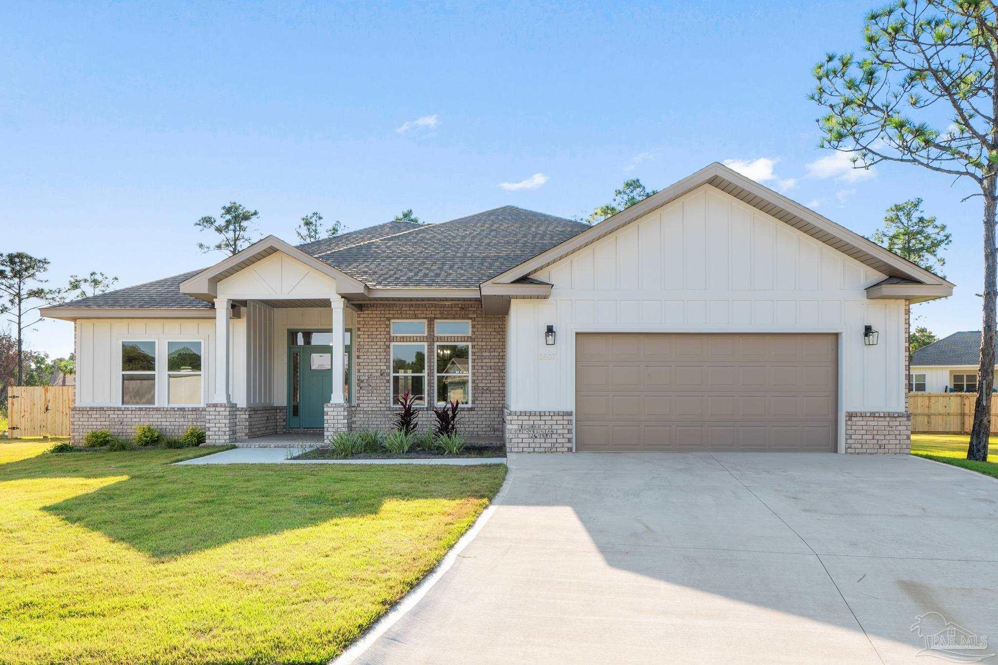 a view of a house with a yard and garage