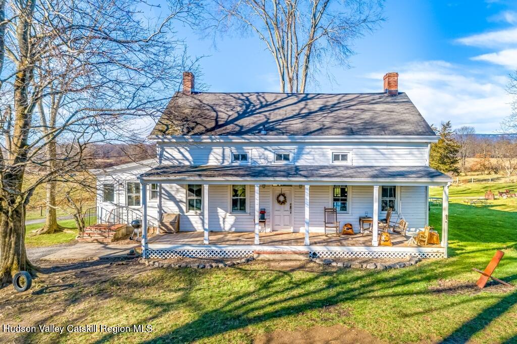 a view of a house with backyard porch and sitting area