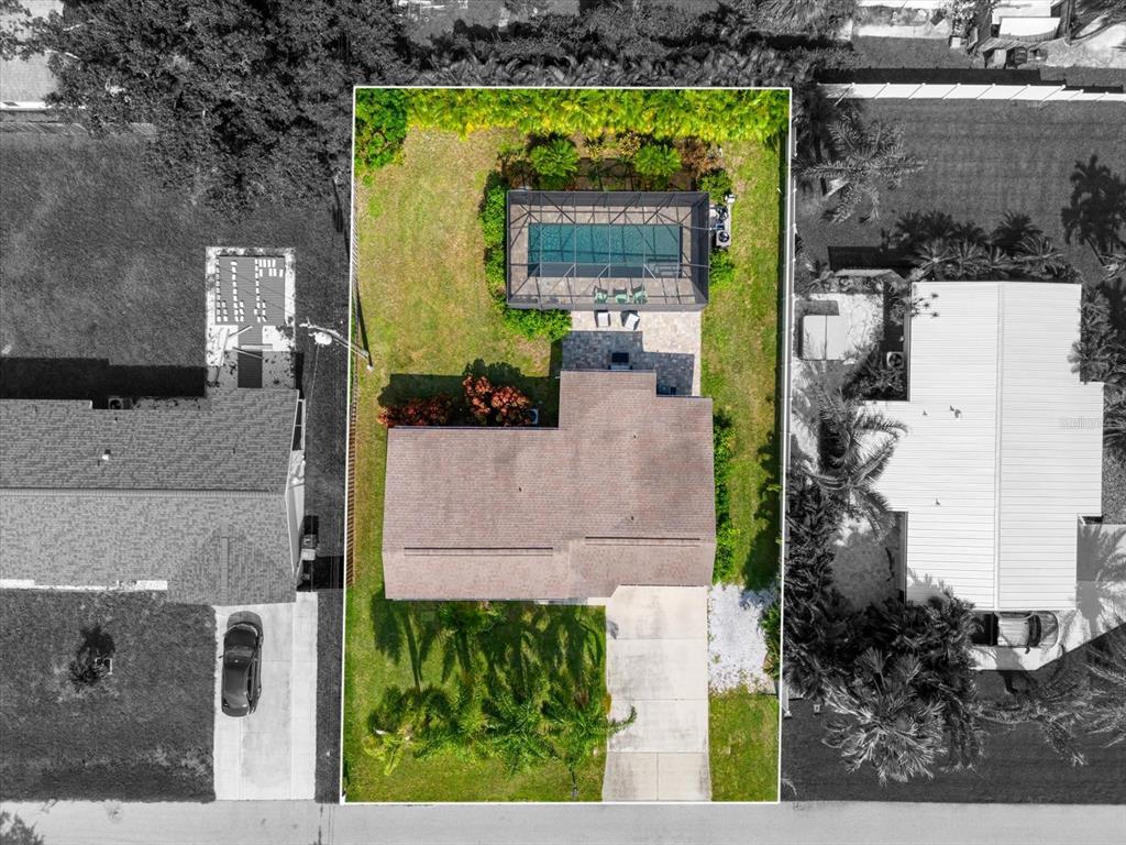 an aerial view of a house with a yard