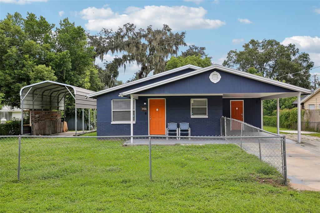 a view of a house with a yard and porch