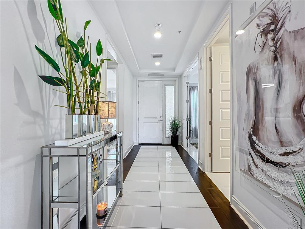 a view of a hallway to a potted plant