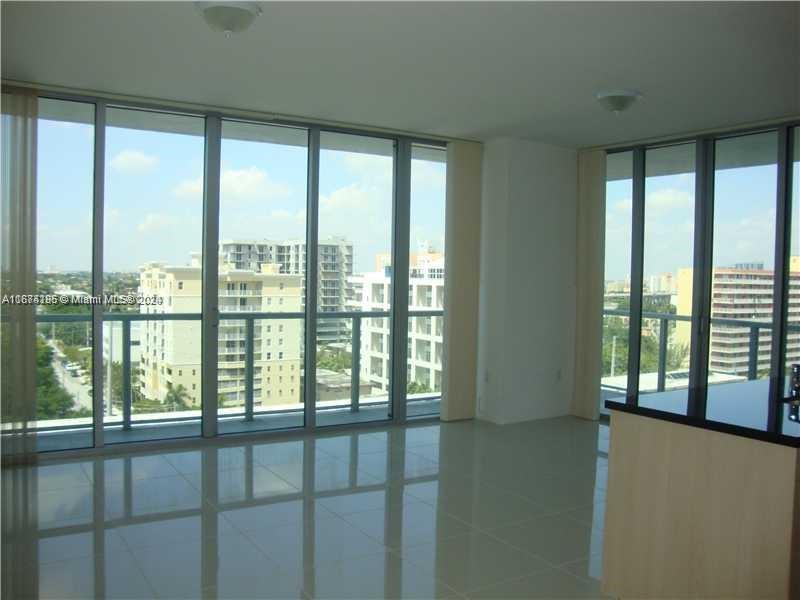 a view of an empty room with a large window