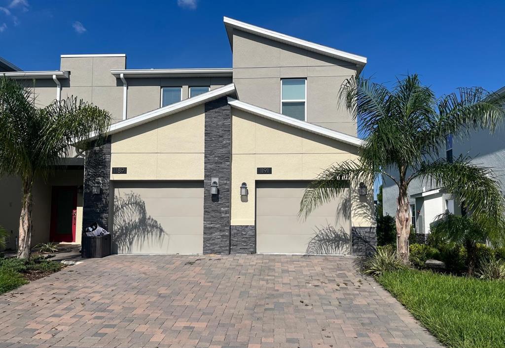 a view of a house with a yard and garage