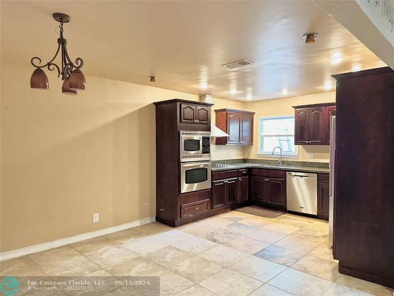 Living room kitchen areaDishwasher/refrigerator, stove, oven , microwave wood cabinets, granite countertops.