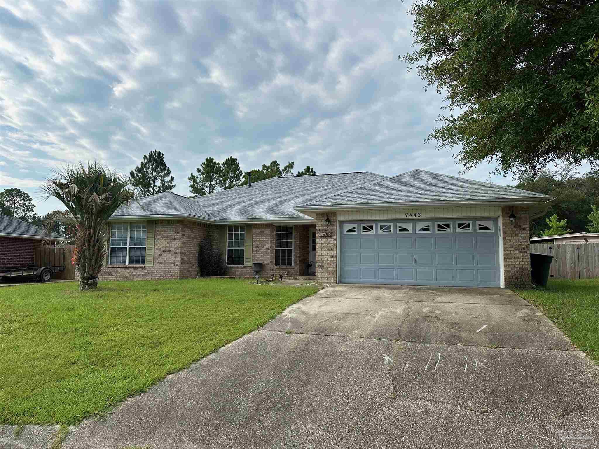 a view of a house with a yard and garage