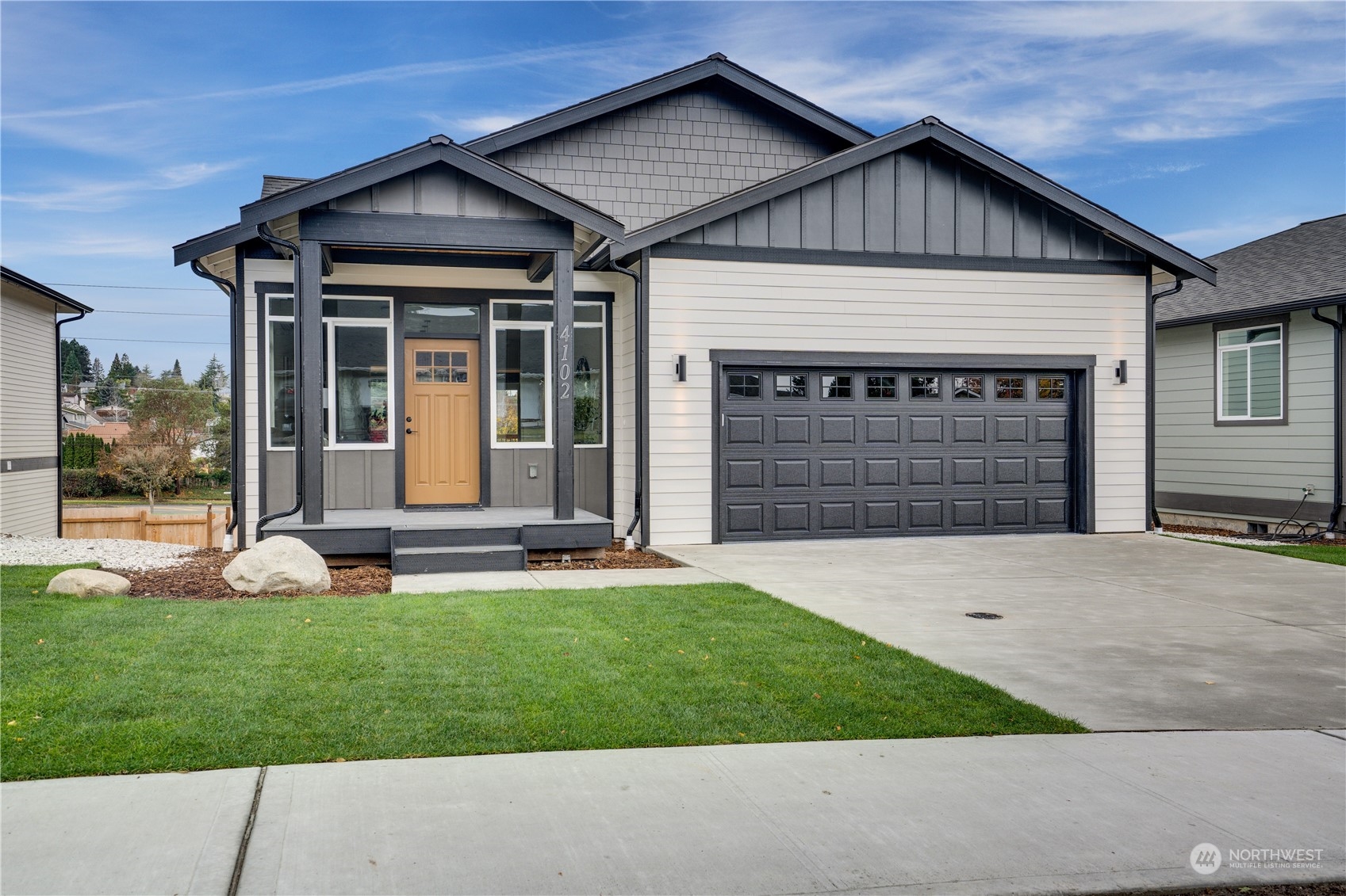 a front view of a house with a yard and garage