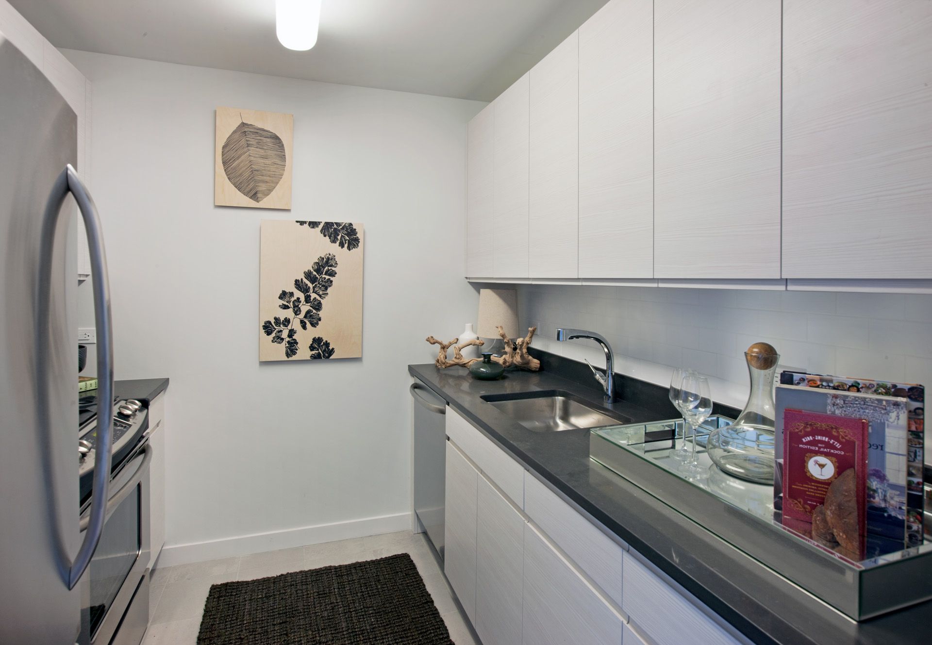 a kitchen with stainless steel appliances granite countertop a sink and a stove