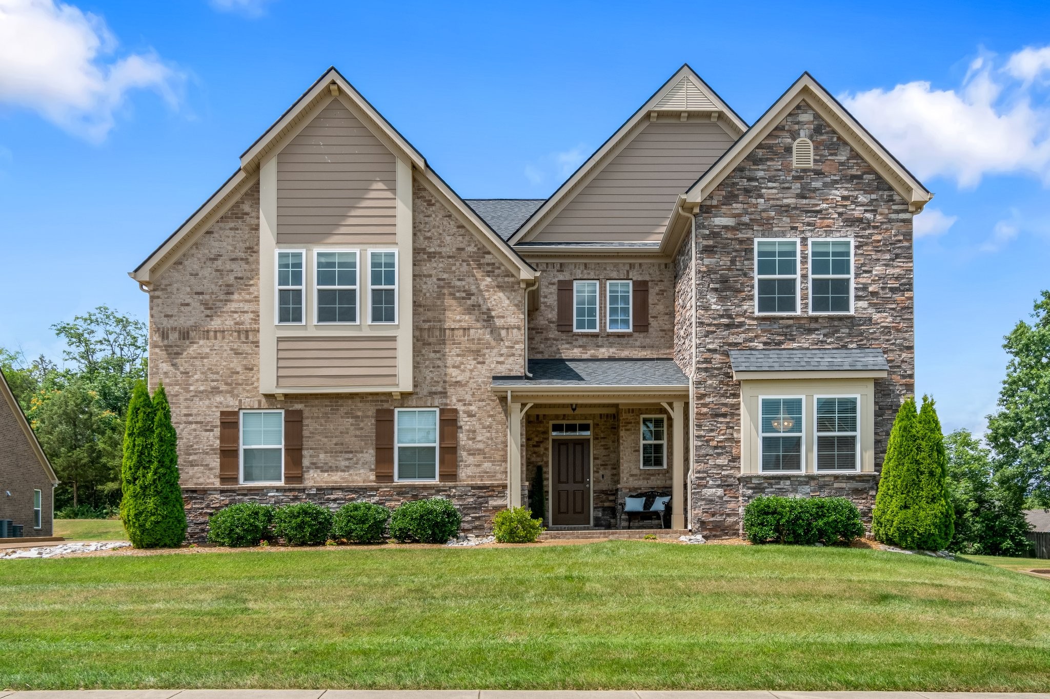 a front view of a house with a yard