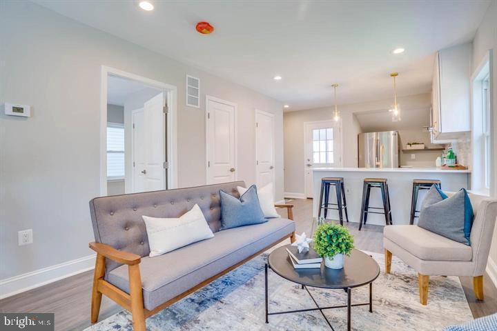 a living room with furniture and kitchen view