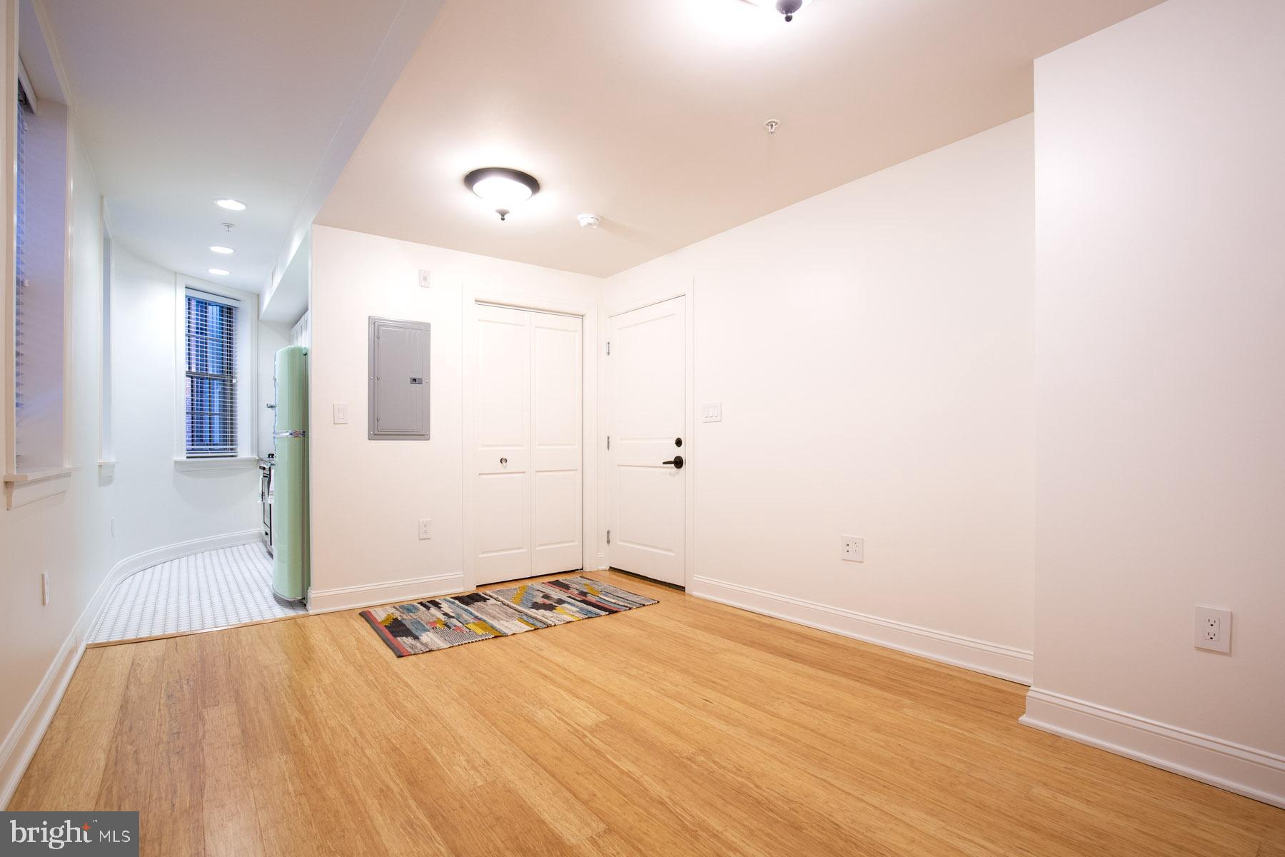 a view of a room with wooden floor and white walls