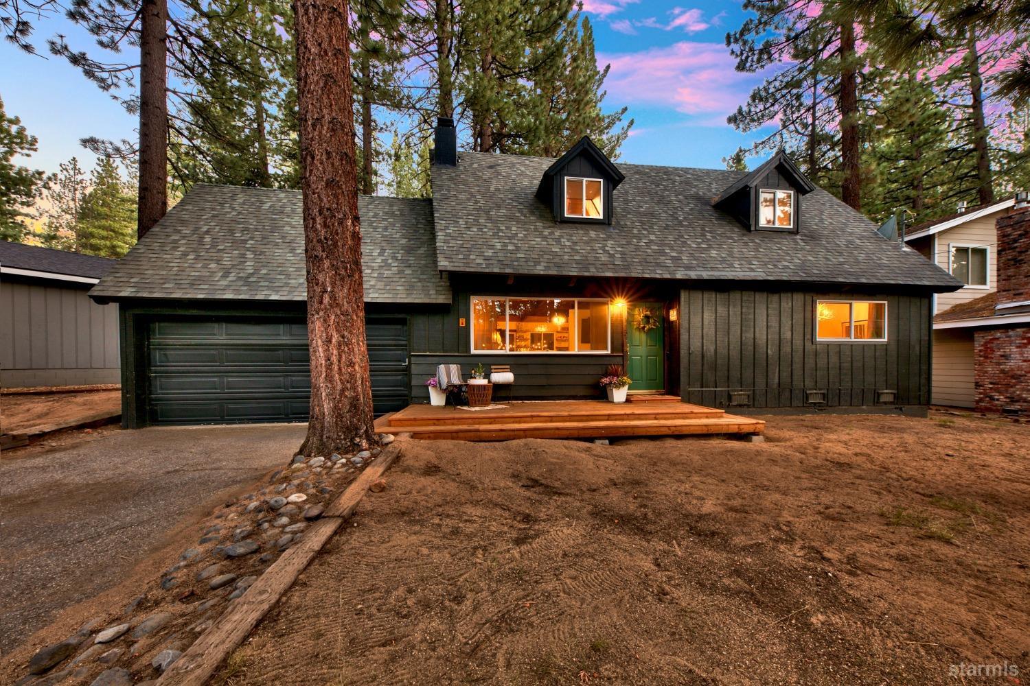 a front view of a house with yard and garage