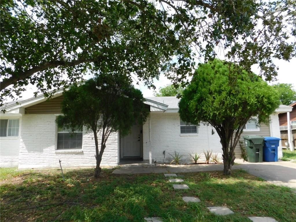 a house that has a tree in front of the house