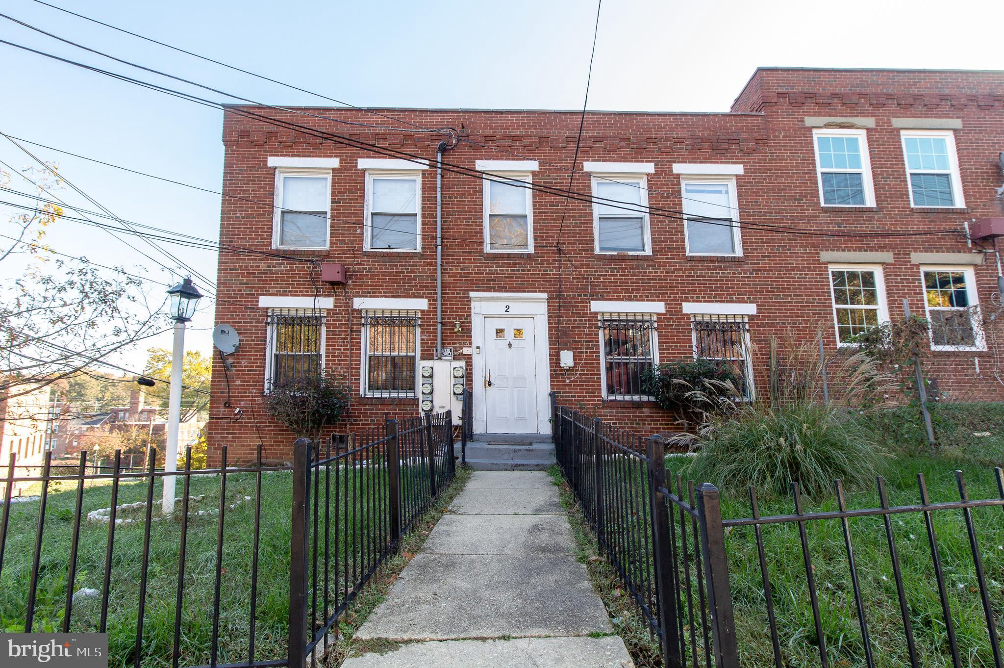 a view of a brick building next to a yard