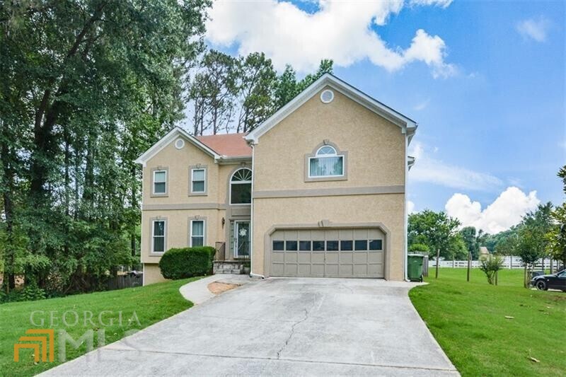 a view of house with yard and green space