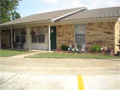 a front view of a house with a yard and a garage