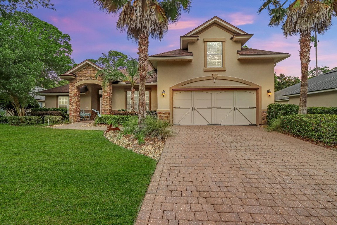 a front view of a house with a yard and garage