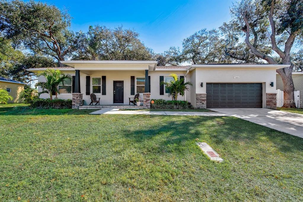 a front view of house with yard and green space