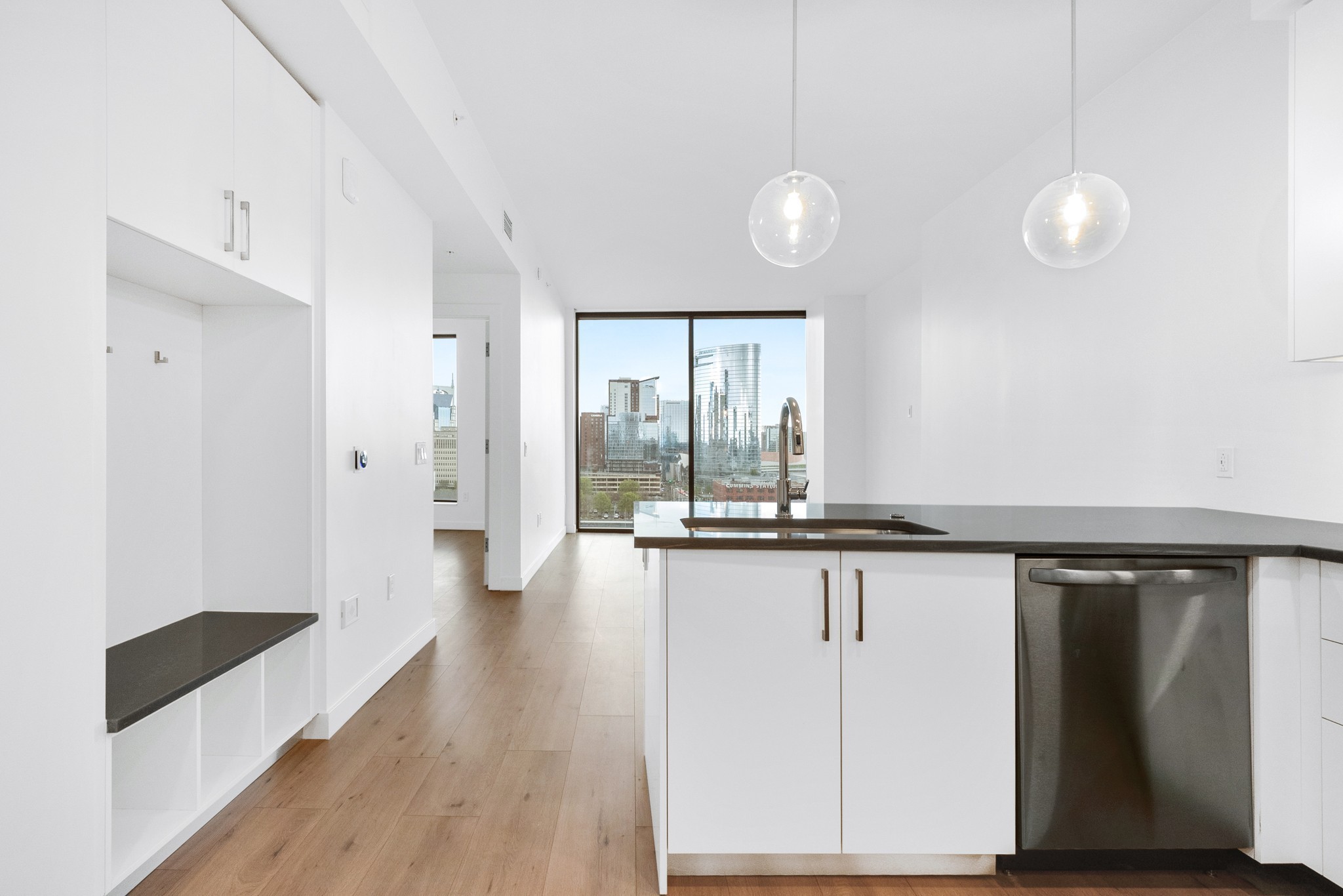 a view of a large kitchen with wooden floor and a window