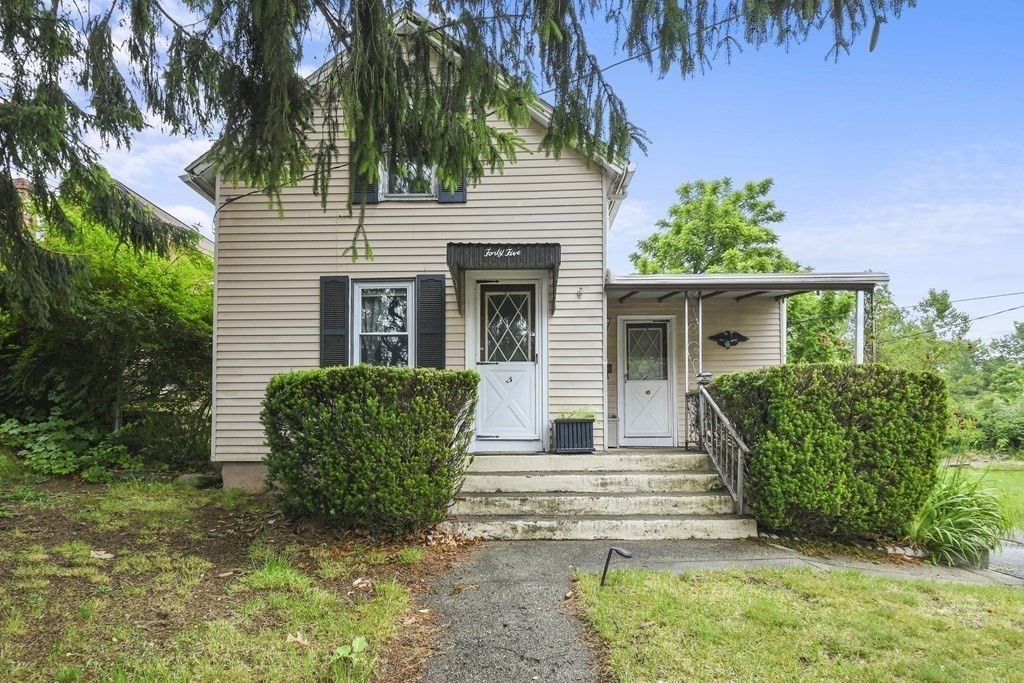 a view of a house with a yard and plants