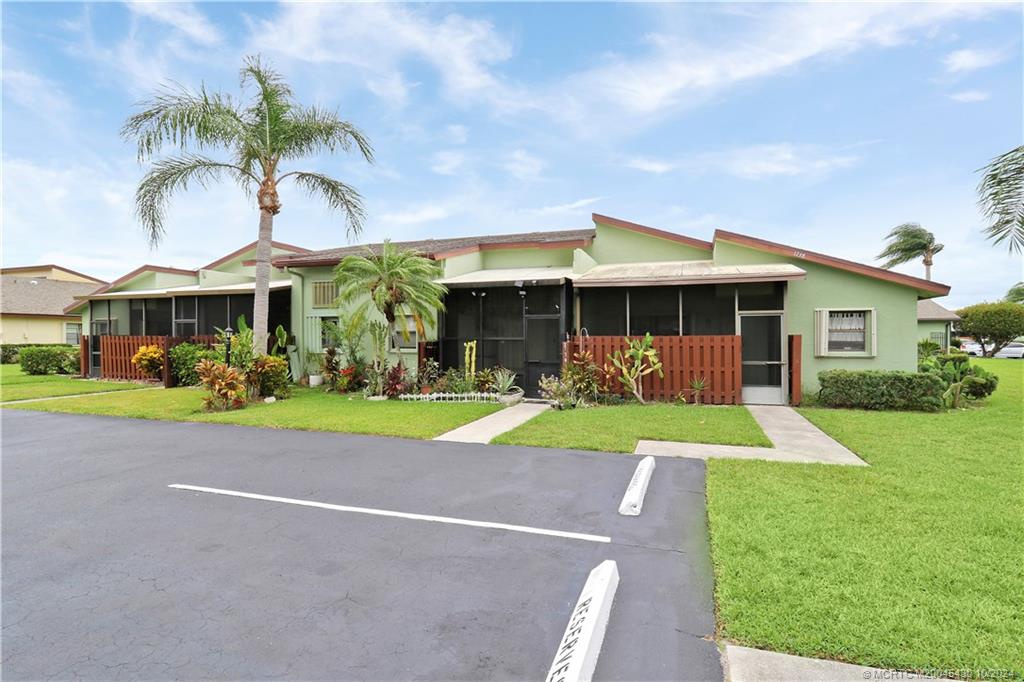 a front view of house with yard and green space