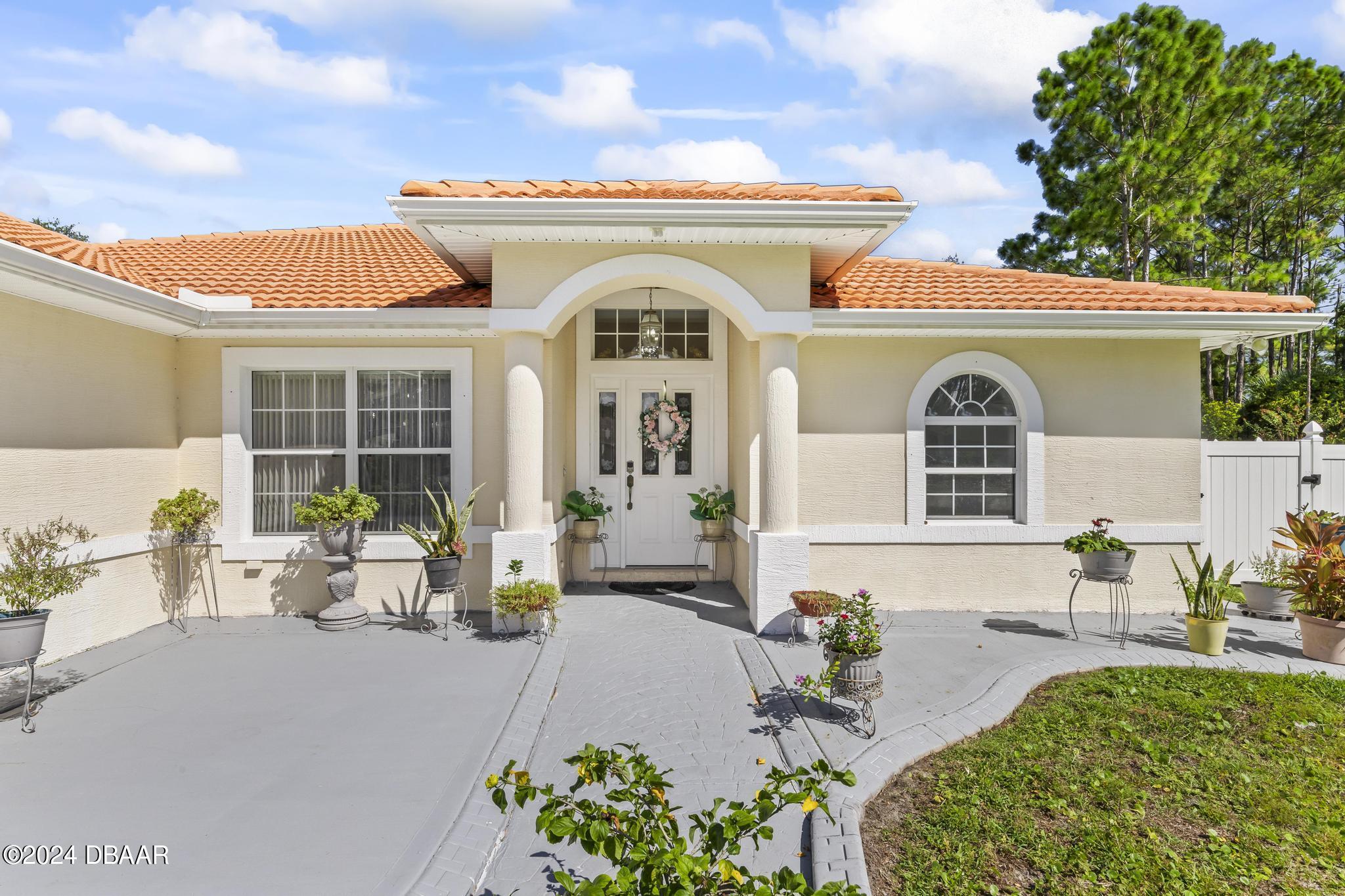 a front view of a house with outdoor seating