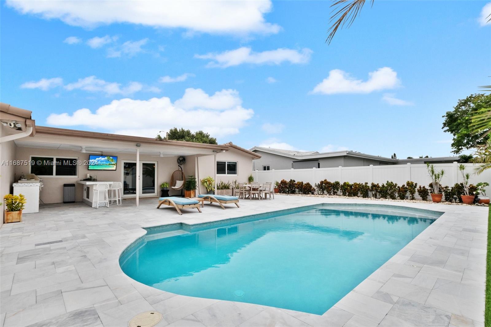 a view of a house with swimming pool and sitting area