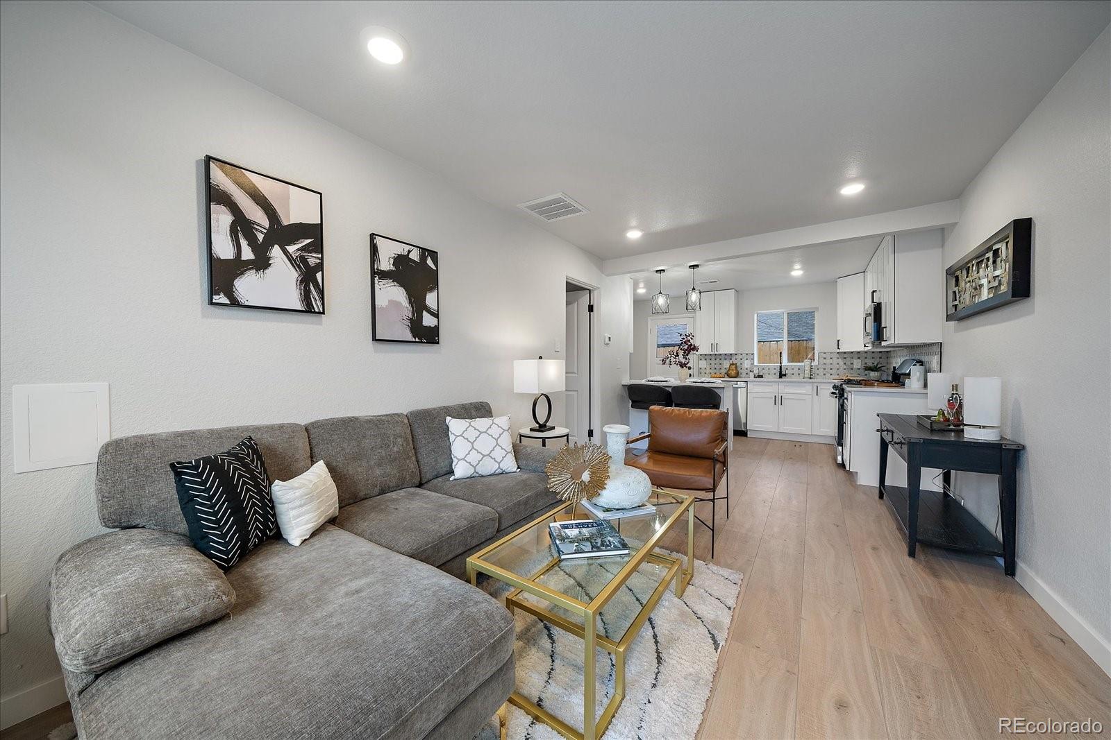 a living room with furniture and kitchen view