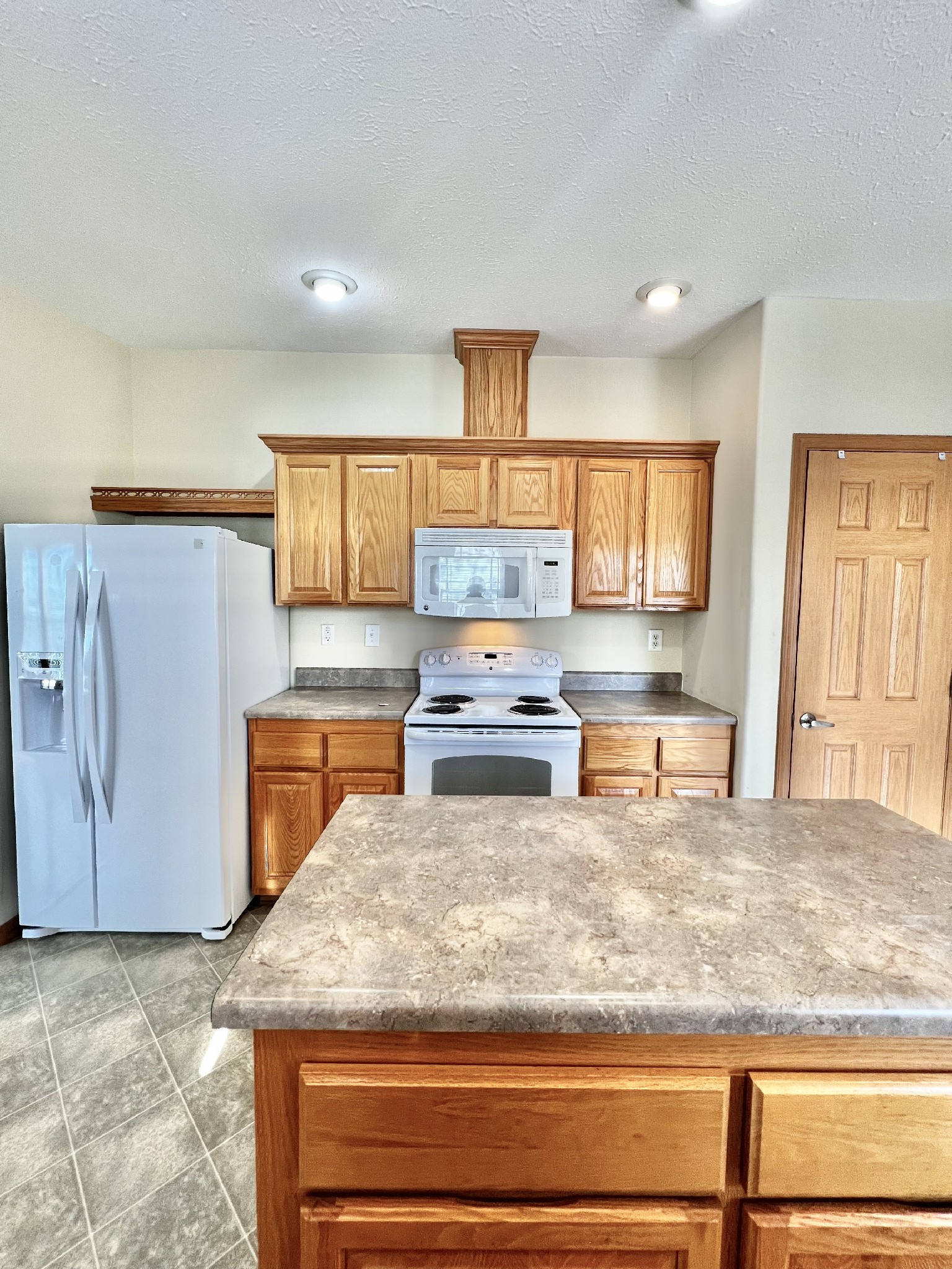 a kitchen with stainless steel appliances granite countertop a sink stove and cabinets