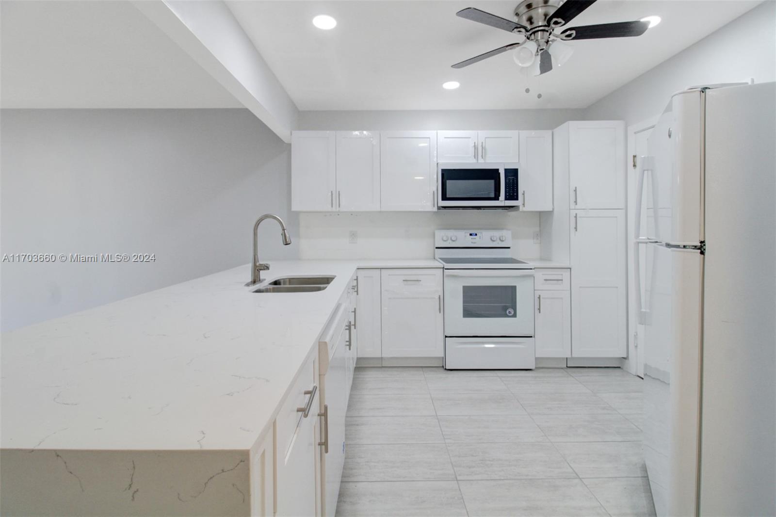 a kitchen with a sink cabinets and stainless steel appliances