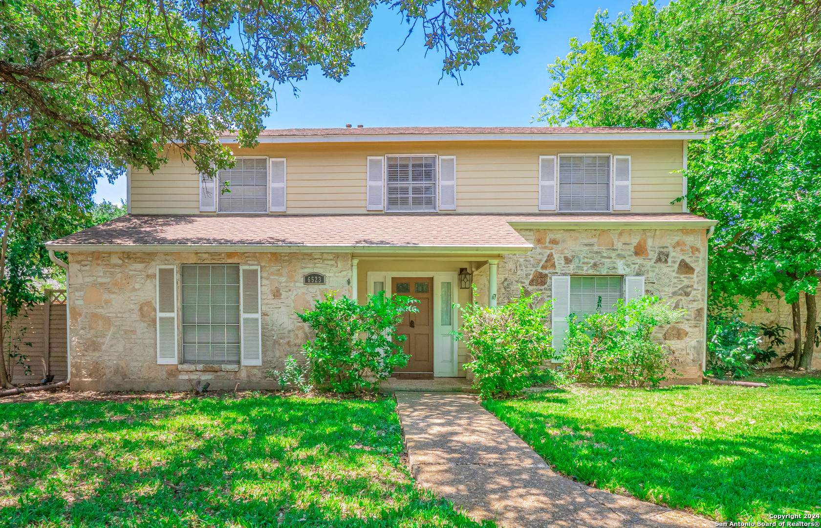 front view of a house with a yard