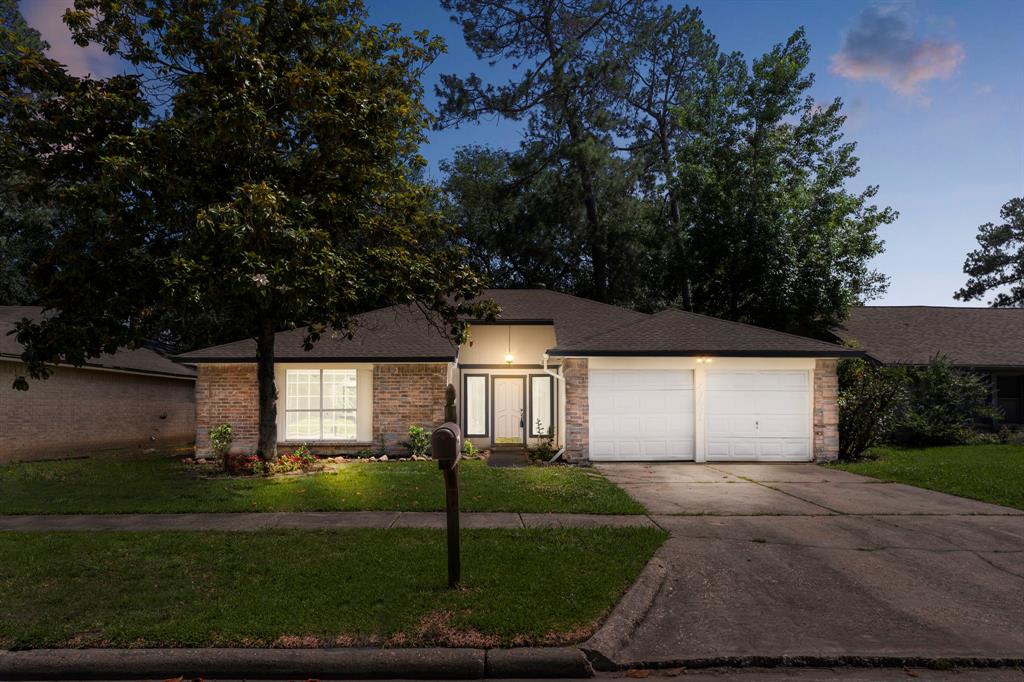 a front view of a house with a yard and a garage